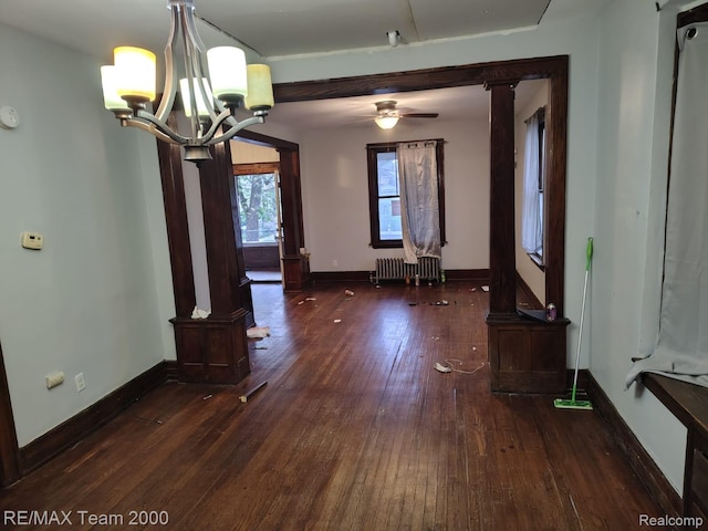 1601 Lawndale St, Highland Park, MI 48209 - unfurnished dining area with radiator, hardwood / wood-style flooring, a chandelier, and baseboards
