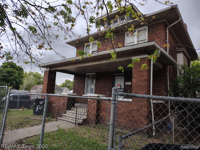 1601 Lawndale St, Highland Park, MI 48209 - view of front of house with brick siding, a porch, and a fenced front yard