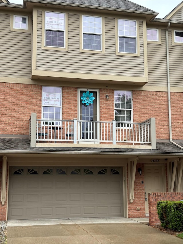 56645 Long Island Dr, Shelby Twp, MI 48316 - view of property featuring brick siding, a balcony, and an attached garage