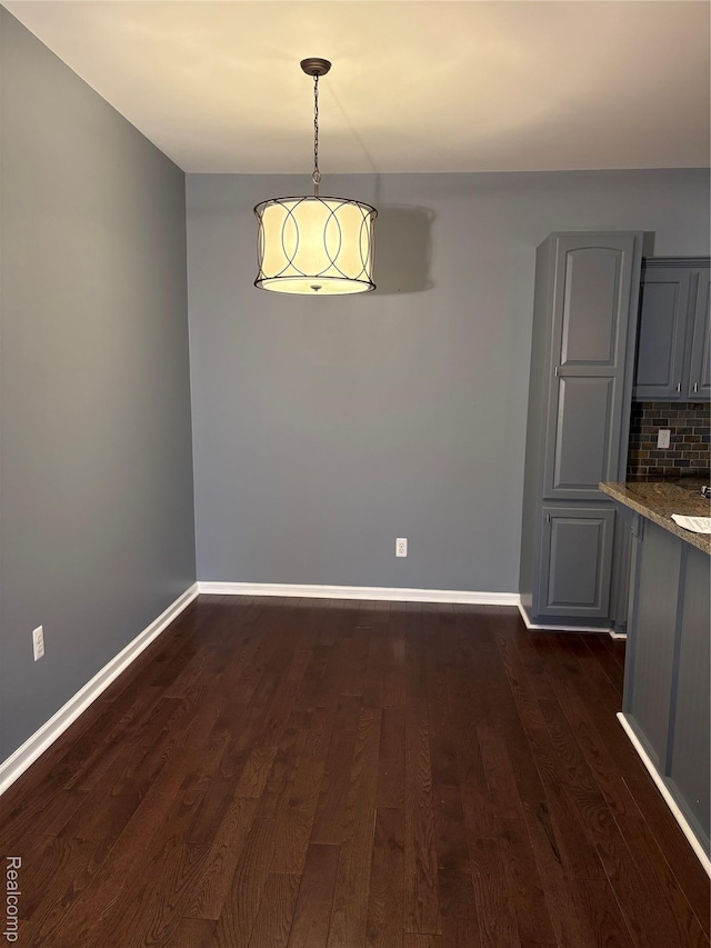 56645 Long Island Dr, Shelby Twp, MI 48316 - unfurnished dining area with dark wood finished floors and baseboards