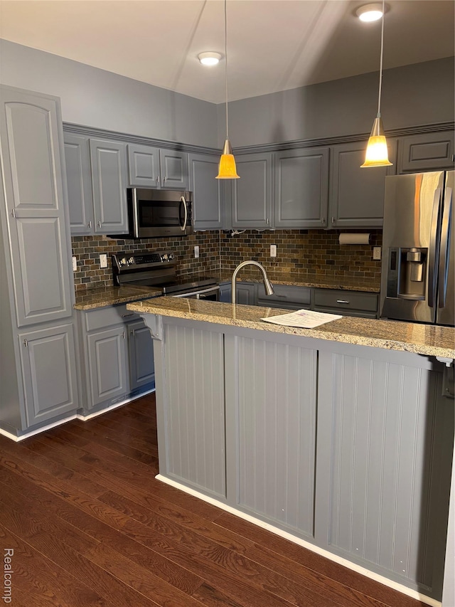 56645 Long Island Dr, Shelby Twp, MI 48316 - kitchen featuring stainless steel appliances, gray cabinetry, backsplash, light stone countertops, and dark wood-style floors