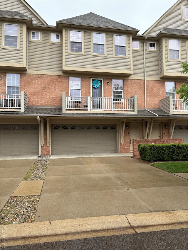 56645 Long Island Dr, Shelby Twp, MI 48316 - view of property with a garage, brick siding, and concrete driveway