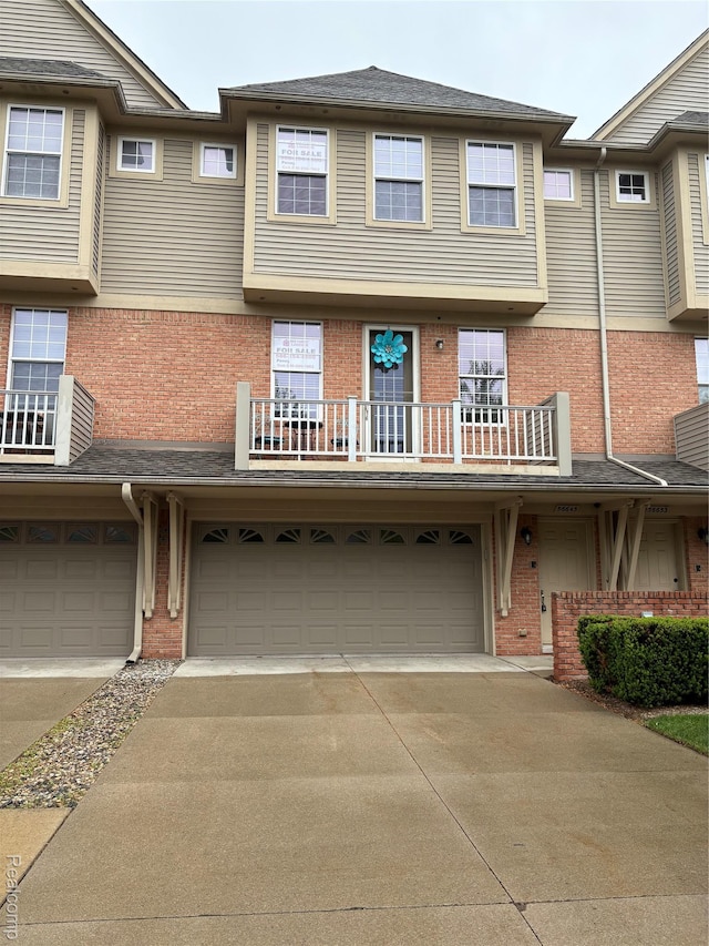 56645 Long Island Dr, Shelby Twp, MI 48316 - multi unit property featuring a garage, concrete driveway, brick siding, and a balcony