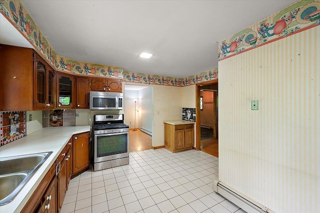 2100 Delhi W, Ann Arbor, MI 48103 - kitchen with stainless steel appliances, a sink, a baseboard radiator, light countertops, and wallpapered walls