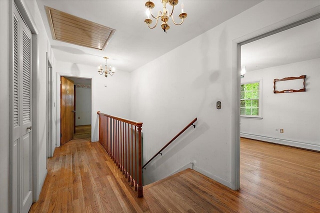 2100 Delhi W, Ann Arbor, MI 48103 - corridor featuring a chandelier, an upstairs landing, wood finished floors, a baseboard radiator, and baseboards