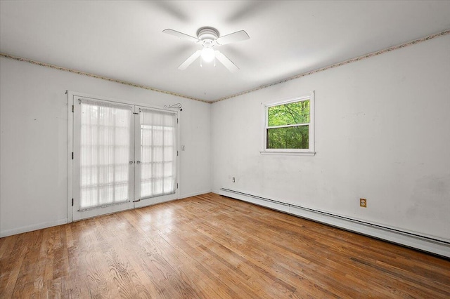 2100 Delhi W, Ann Arbor, MI 48103 - empty room featuring a baseboard heating unit, a ceiling fan, and wood finished floors