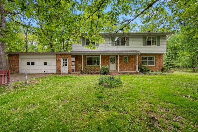 2100 Delhi W, Ann Arbor, MI 48103 - traditional home featuring a garage, a front yard, brick siding, and driveway
