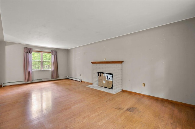 2100 Delhi W, Ann Arbor, MI 48103 - unfurnished living room featuring wood finished floors, a fireplace, a baseboard radiator, and baseboards