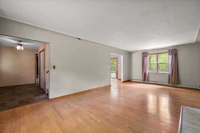 2100 Delhi W, Ann Arbor, MI 48103 - empty room with light wood-style floors, a baseboard radiator, and baseboards