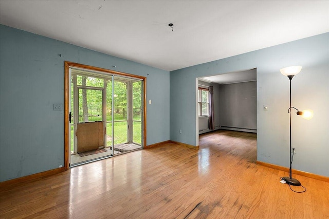 2100 Delhi W, Ann Arbor, MI 48103 - spare room featuring baseboards, light wood-style flooring, a pendent fire sprinkler, and baseboard heating