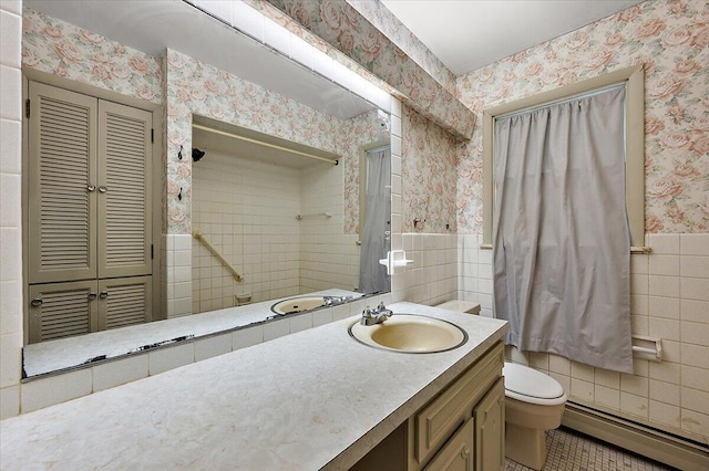 2100 Delhi W, Ann Arbor, MI 48103 - bathroom featuring wallpapered walls, a baseboard radiator, tile walls, toilet, and vanity