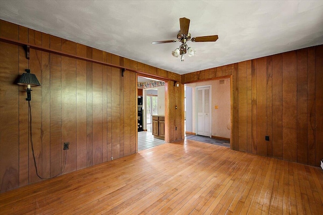 2100 Delhi W, Ann Arbor, MI 48103 - empty room with wood-type flooring, wooden walls, and ceiling fan