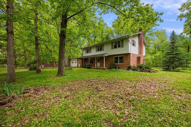 2100 Delhi W, Ann Arbor, MI 48103 - traditional-style home featuring a garage, a chimney, brick siding, and a front lawn