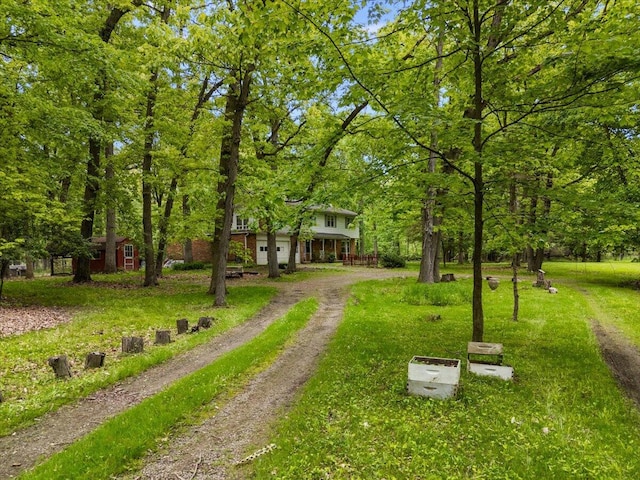 2100 Delhi W, Ann Arbor, MI 48103 - view of property's community featuring dirt driveway, a yard, and a garage