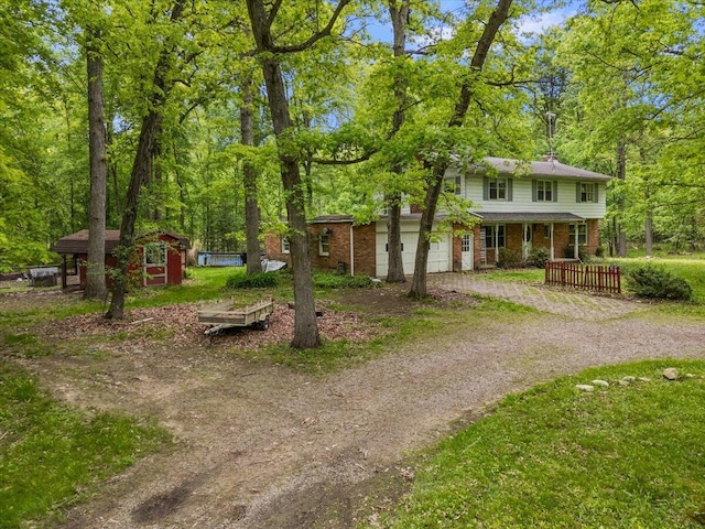2100 Delhi W, Ann Arbor, MI 48103 - view of front of property with brick siding, driveway, a porch, and an outdoor structure