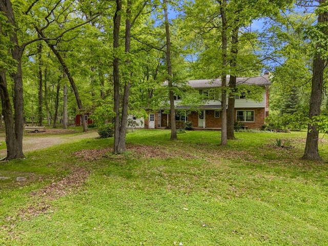 2100 Delhi W, Ann Arbor, MI 48103 - view of front of property with a front yard, a chimney, and brick siding