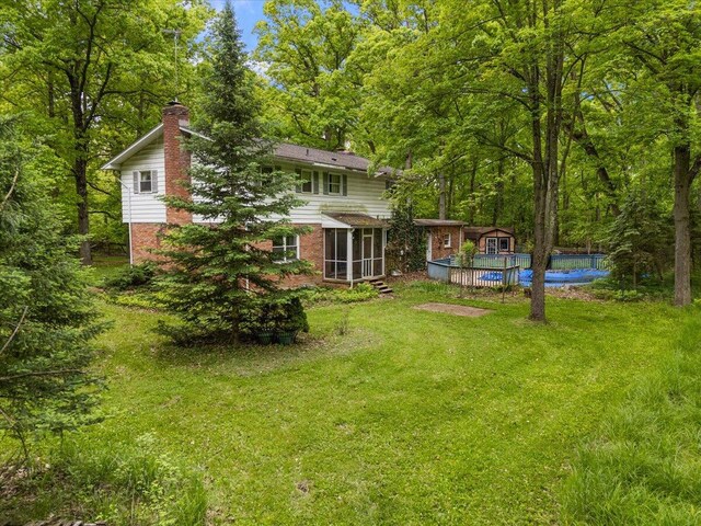 2100 Delhi W, Ann Arbor, MI 48103 - view of grassy yard with a sunroom, an outdoor pool, and an outdoor structure