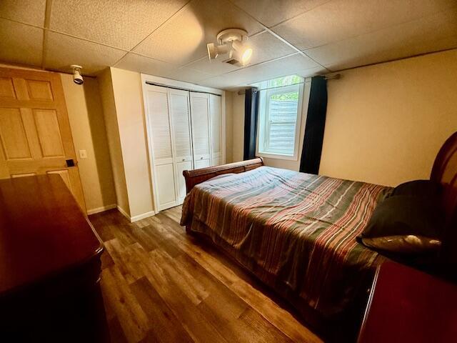 307 W 30th St, Holland, MI 49423 - bedroom featuring wood finished floors, a closet, and baseboards
