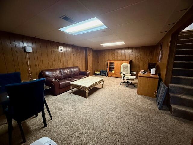 307 W 30th St, Holland, MI 49423 - carpeted living area featuring stairway and wooden walls