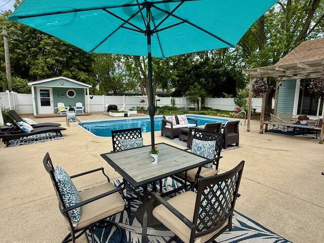 307 W 30th St, Holland, MI 49423 - fenced backyard with a pergola, a patio, outdoor dining space, and an outdoor structure