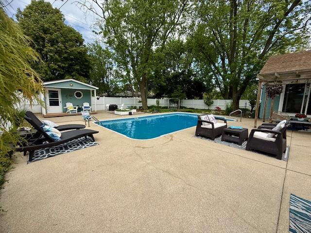307 W 30th St, Holland, MI 49423 - view of pool with a patio area, a fenced backyard, an outbuilding, and an exterior structure