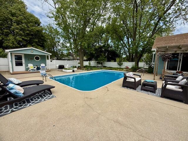307 W 30th St, Holland, MI 49423 - view of swimming pool with a patio, a fenced backyard, an outbuilding, a storage structure, and outdoor lounge area
