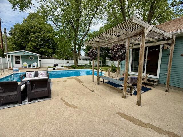 307 W 30th St, Holland, MI 49423 - view of pool featuring a pergola, a fenced backyard, a patio area, and an outbuilding