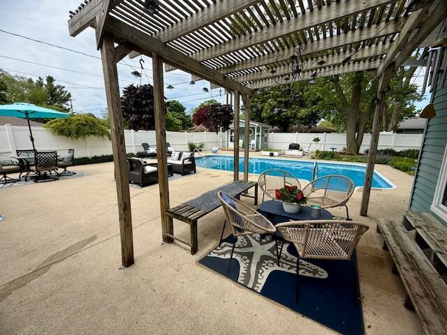 307 W 30th St, Holland, MI 49423 - view of swimming pool with a fenced backyard, a pergola, a patio, and outdoor dining area