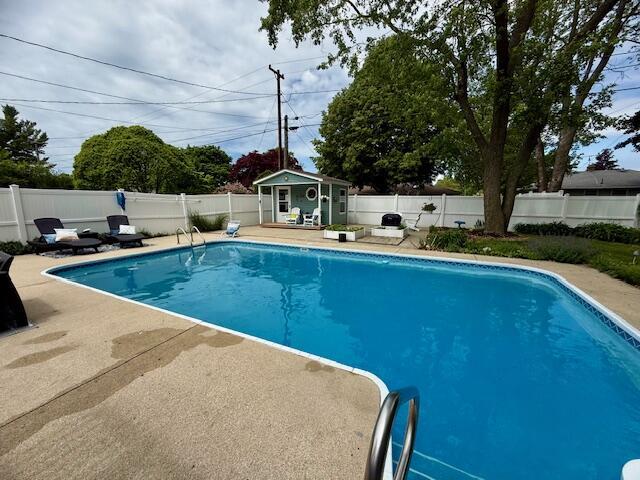 307 W 30th St, Holland, MI 49423 - view of swimming pool with an outdoor structure, a fenced backyard, and a patio area