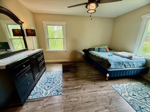 307 W 30th St, Holland, MI 49423 - bedroom with light wood-type flooring, baseboards, and ceiling fan