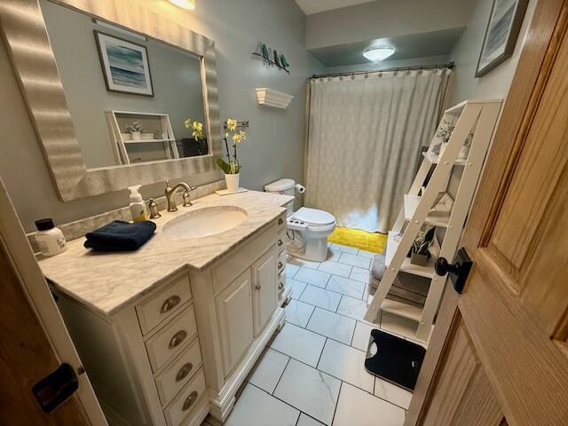 307 W 30th St, Holland, MI 49423 - full bathroom featuring vanity, toilet, marble finish floors, and a shower with shower curtain