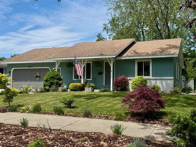 307 W 30th St, Holland, MI 49423 - single story home featuring a garage, a front lawn, and brick siding