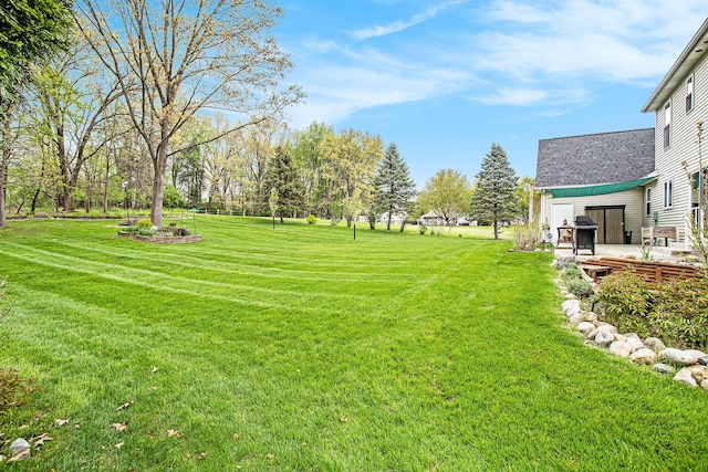 10420 Roger St, Portage, MI 49002 - view of green lawn featuring a patio area