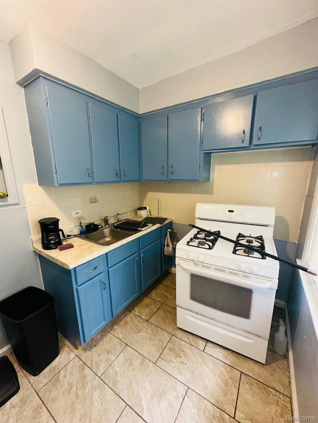 47 W Rockwood St, Ecorse, MI 48229 - kitchen featuring white range with gas cooktop, blue cabinetry, light countertops, and a sink