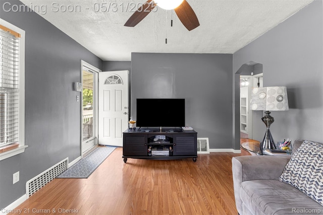 17621 Wood St, Melvindale, MI 48122 - living area with a ceiling fan, wood finished floors, a textured ceiling, baseboards, and arched walkways