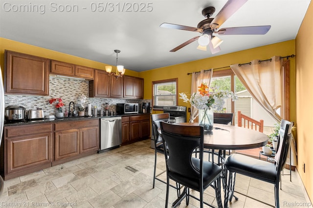 17621 Wood St, Melvindale, MI 48122 - kitchen featuring appliances with stainless steel finishes, dark countertops, decorative backsplash, a sink, and a ceiling fan