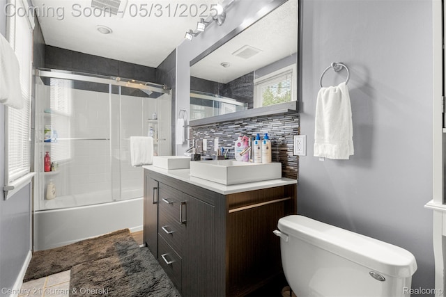 17621 Wood St, Melvindale, MI 48122 - bathroom featuring vanity, bath / shower combo with glass door, toilet, and tasteful backsplash
