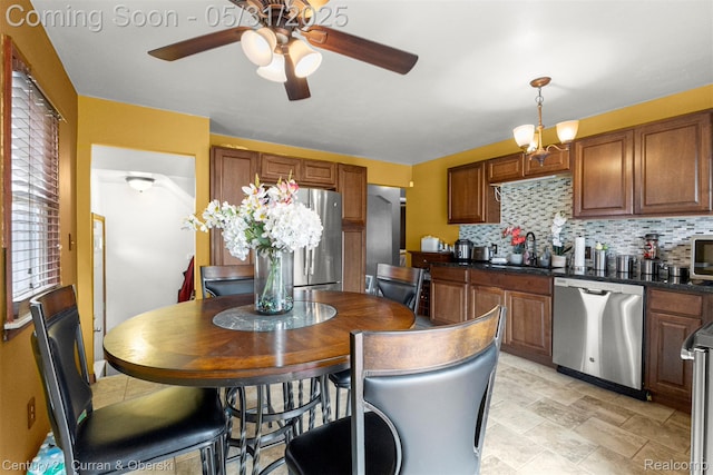 17621 Wood St, Melvindale, MI 48122 - kitchen with appliances with stainless steel finishes, a ceiling fan, dark countertops, backsplash, and a sink