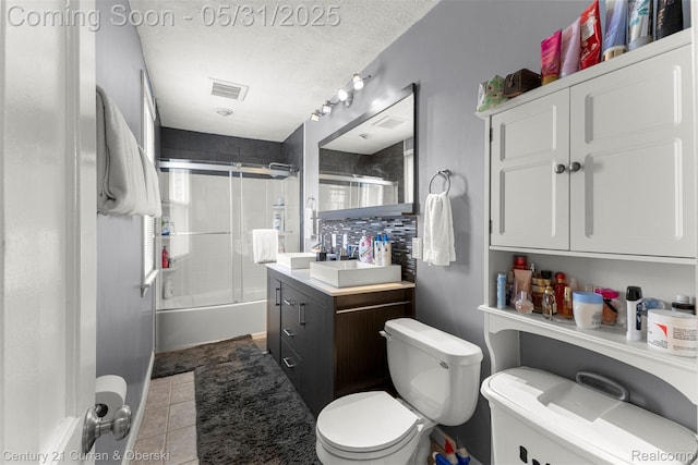 17621 Wood St, Melvindale, MI 48122 - bathroom featuring toilet, enclosed tub / shower combo, vanity, a textured ceiling, and tile patterned flooring