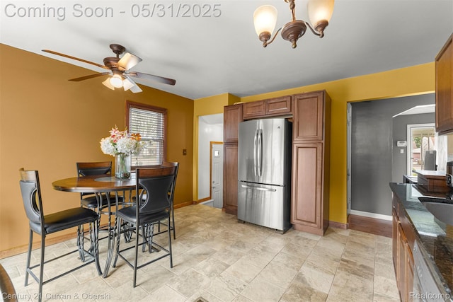 17621 Wood St, Melvindale, MI 48122 - dining room with a ceiling fan, baseboards, a chandelier, and healthy amount of natural light
