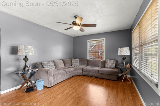 17621 Wood St, Melvindale, MI 48122 - living room featuring wood finished floors, a ceiling fan, baseboards, and a textured ceiling