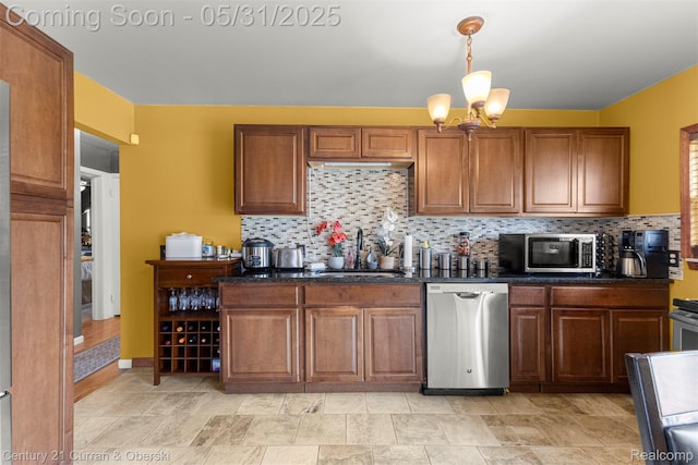 17621 Wood St, Melvindale, MI 48122 - kitchen featuring stainless steel appliances, a sink, decorative backsplash, and brown cabinets
