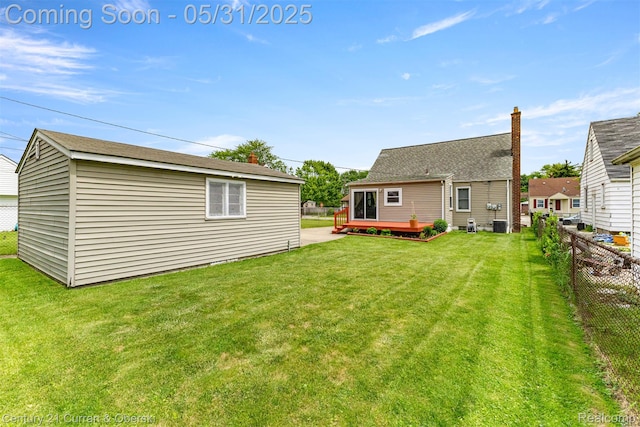17621 Wood St, Melvindale, MI 48122 - back of property with a wooden deck, an outbuilding, and central AC unit