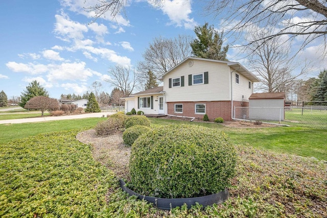 2615 Yosemite St, Saginaw, MI 48603 - view of front of house with brick siding, a garage, and driveway