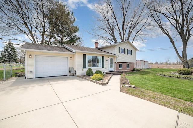 2615 Yosemite St, Saginaw, MI 48603 - tri-level home with driveway, a garage, and a chimney