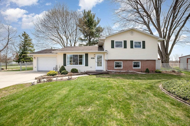 2615 Yosemite St, Saginaw, MI 48603 - tri-level home featuring driveway, a garage, and brick siding