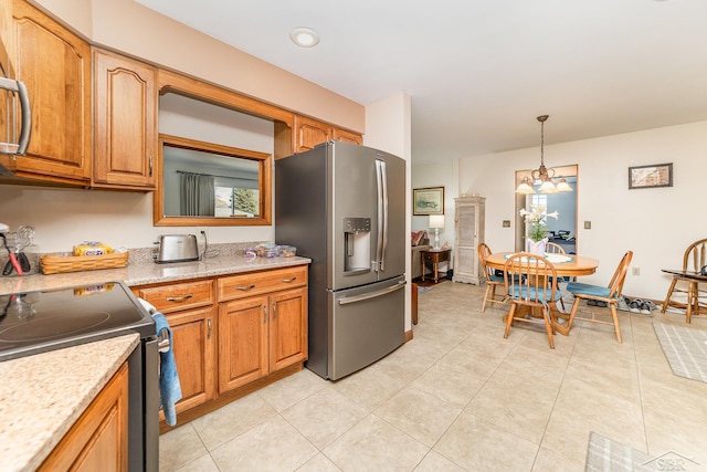 2615 Yosemite St, Saginaw, MI 48603 - kitchen featuring appliances with stainless steel finishes, a chandelier, hanging light fixtures, brown cabinets, and light tile patterned flooring