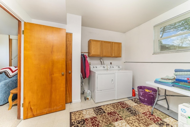 2615 Yosemite St, Saginaw, MI 48603 - laundry room featuring cabinet space, washer and clothes dryer, baseboards, and light floors