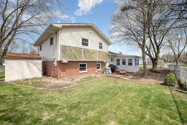2615 Yosemite St, Saginaw, MI 48603 - back of property featuring brick siding and a sunroom