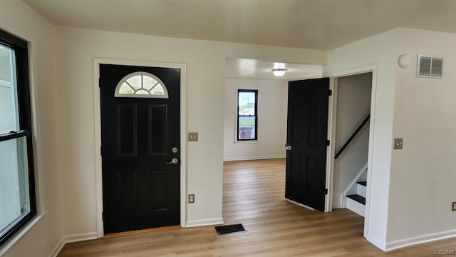 810 Division St, Adrian, MI 49221 - entryway featuring light wood-style floors, baseboards, and stairway